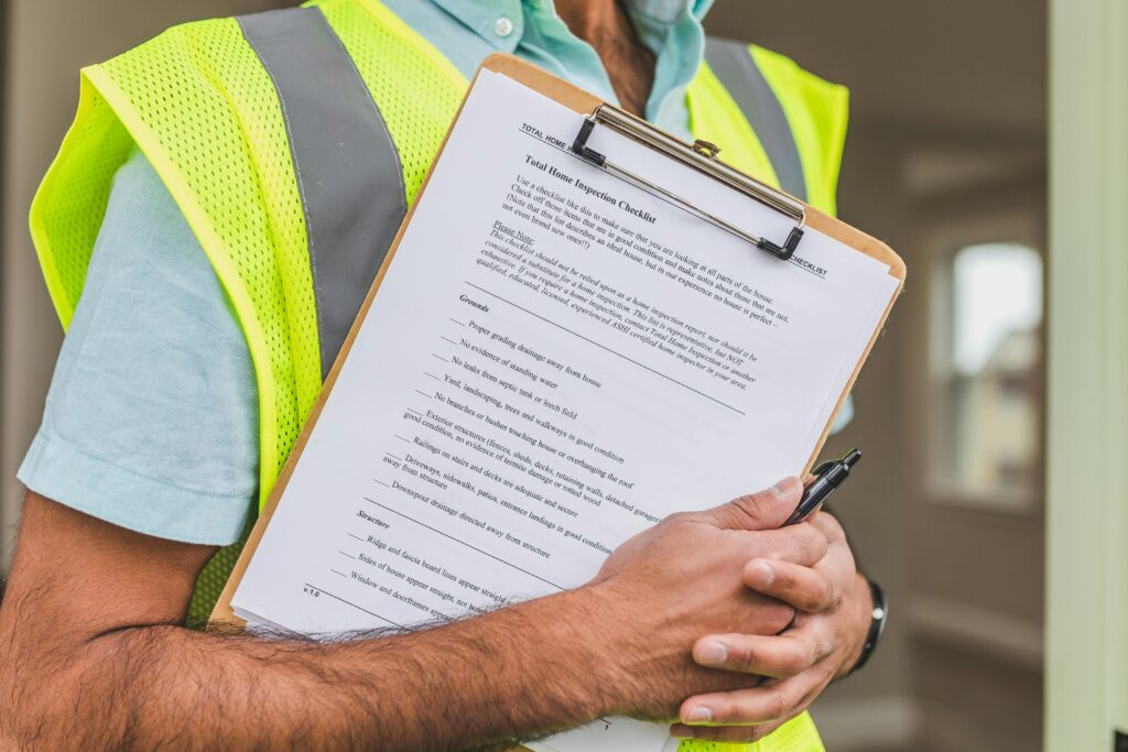 Inspector holding a home inspection checklist during the final inspection phase of a Long Island renovation.